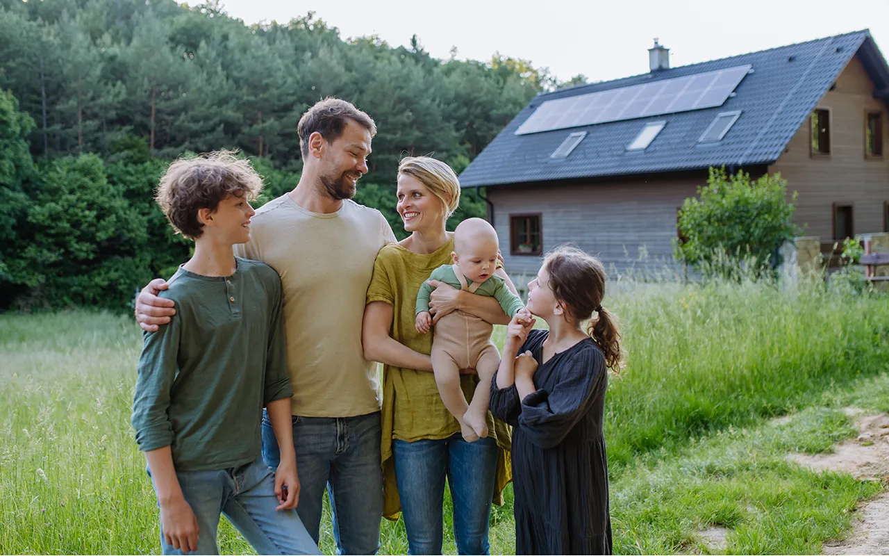 happy-family-near-their-house-with-solar-panels-a-2024-10-18-09-57-56-utc